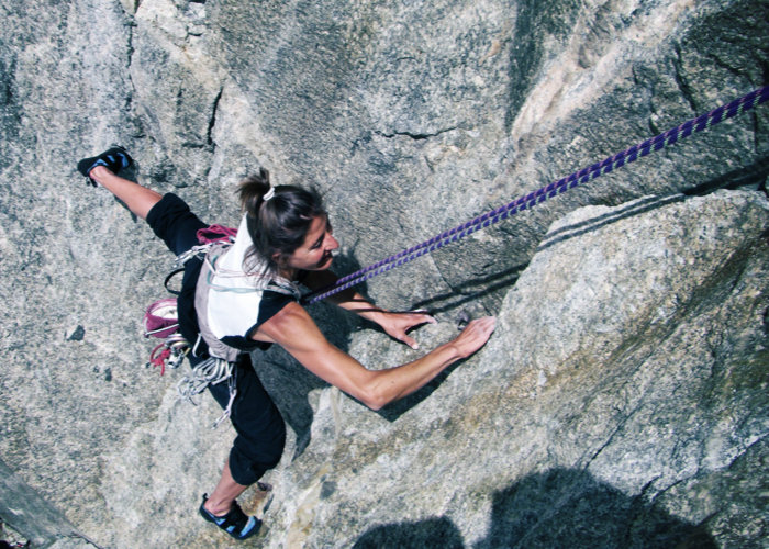 ragazza arrampica in parete